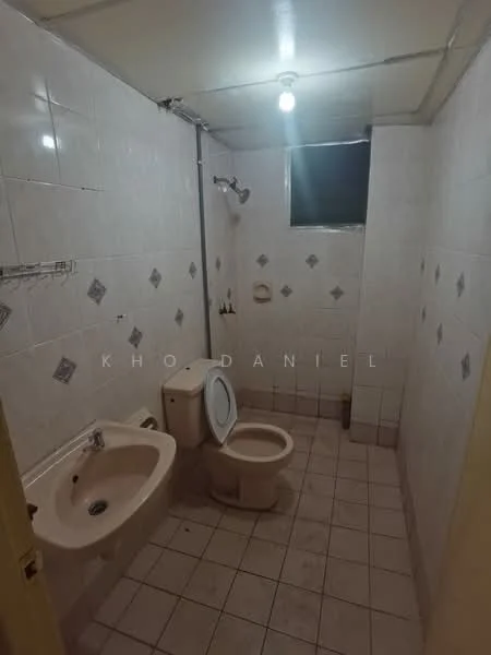 Bathroom features: white tiled walls, light grey tiled flooring, single-sink vanity, toilet, shower with wall-mounted showerhead, window for natural light, mirror above sink, soap holder, towel rack.