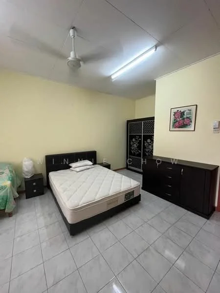 Bedroom features: queen-size bed, upholstered headboard, white bedding, 2 bedside tables, ceiling fan, built-in wardrobe with decorative panels, chest of drawers, framed artwork on wall, tiled flooring, yellow painted walls, overhead fluorescent lighting.