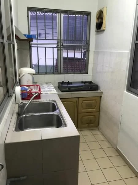 Kitchen features: double-bowl stainless-steel sink, chrome pull-down faucet, built-in gas stove, wood cabinetry, white tiled walls, cream tiled flooring, window with metal grille, exhaust fan, countertop space, kitchen utensils on countertop.
