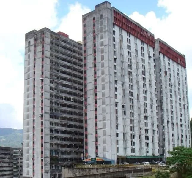Exterior type: high-rise condominium; features: concrete facade with grey and red accents, multiple storeys, balconies on each floor, visible parking area, surrounded by greenery, urban context with mountain backdrop; style: modern.