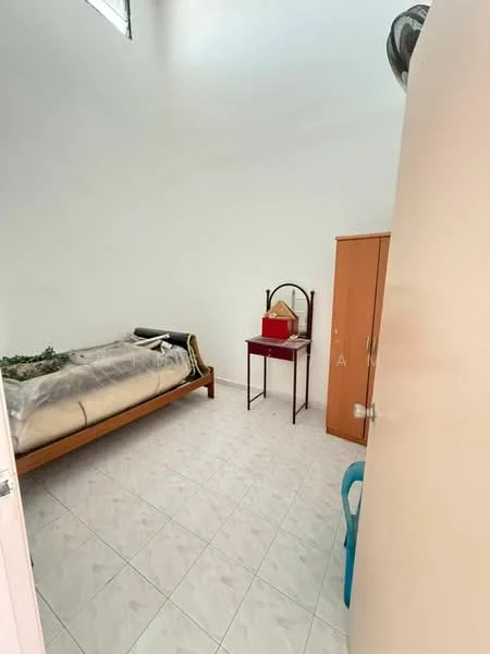 Bedroom features: single bed with bedding, wooden bed frame, white painted walls, tile flooring, wardrobe with wooden finish, small table with red top, chair in blue plastic, ceiling fan.
