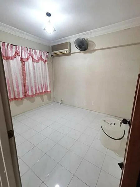 Room features: white painted walls, glossy white tile flooring, ceiling light fixture, wall-mounted air conditioning unit, ceiling fan, curtains with pink and white pattern, one-piece toilet, no visible furniture; style: minimalist.
