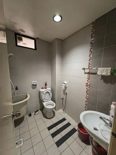 Bathroom features: white tiled walls, grey tiled flooring, single-sink vanity, white basin, chrome basin mixer, toilet, bidet spray, shower with handheld showerhead, small window, recessed ceiling light, towel rack, red accent tiles, bath mat; style: modern.