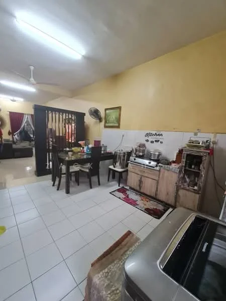 Kitchen features: white tiled flooring, yellow painted walls, ceiling fan, dining table with four chairs, wooden cabinets, stainless-steel sink, countertop with kitchen appliances, decorative wall art, refrigerator, kitchen utensils on countertop, area rug with floral pattern, open layout to living area; style: modern.