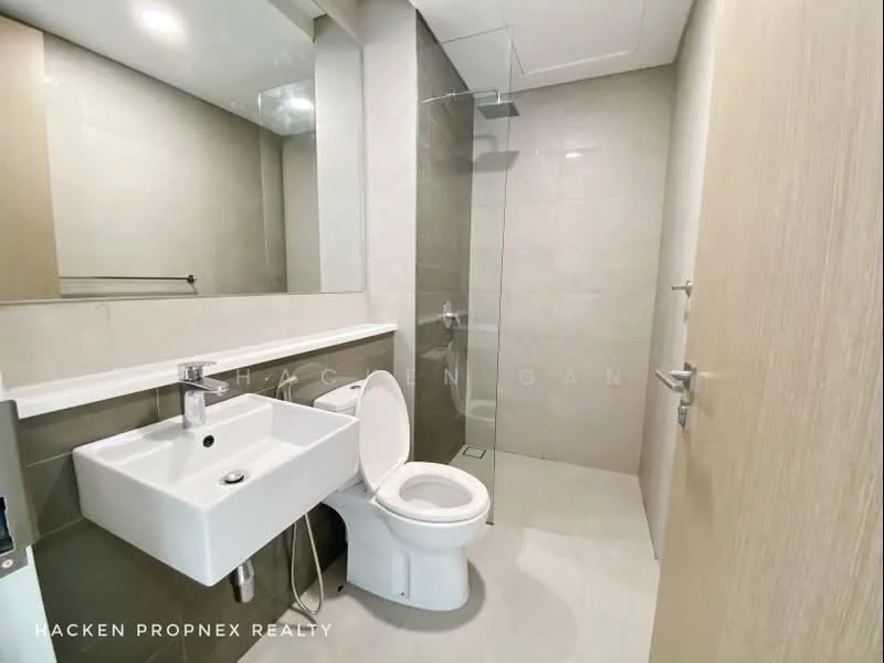 Bathroom features: white ceramic sink, chrome basin mixer faucet, one-piece toilet, walk-in shower with glass enclosure, rain shower head, light grey wall tiles, light grey floor tiles, mirror above sink, white countertop, shower wall with tile cladding; style: modern.