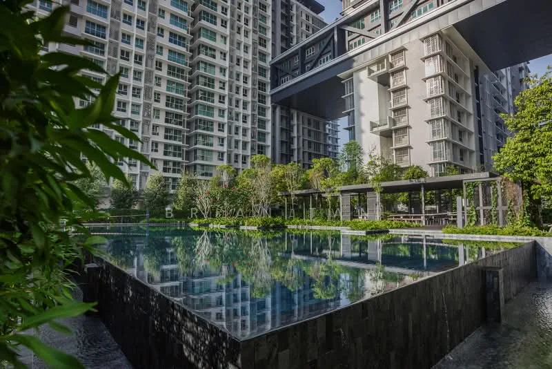 Exterior type: high-rise condominium; features: infinity pool, pool deck with loungers, landscaped garden, mature trees, water feature, glass curtain wall facade, balconies with glass railings, outdoor dining pavilion; style: modern.