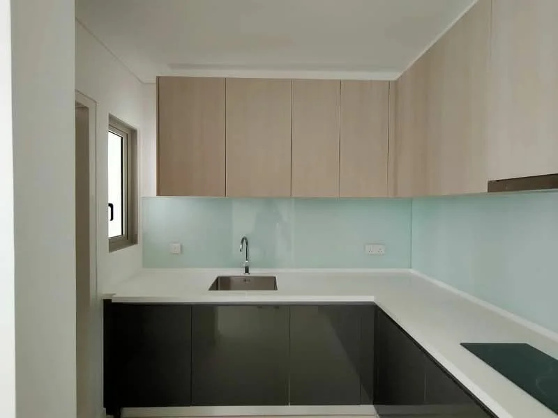 Kitchen features: single-bowl stainless-steel sink, chrome pull-down faucet, white quartz countertop, black lower cabinetry, light wood upper cabinetry, glass backsplash, built-in induction cooktop, wall-mounted range hood, recessed downlights, window with black frame; style: modern.