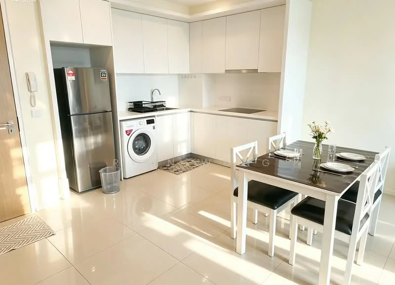 Kitchen features: white cabinetry, black countertop, stainless-steel fridge, front-load washing machine, built-in gas hob, single-bowl stainless-steel sink, chrome pull-down faucet, ceramic tile flooring, recessed downlights, dining table with black surface, 4 white dining chairs, decorative flower vase; style: modern.