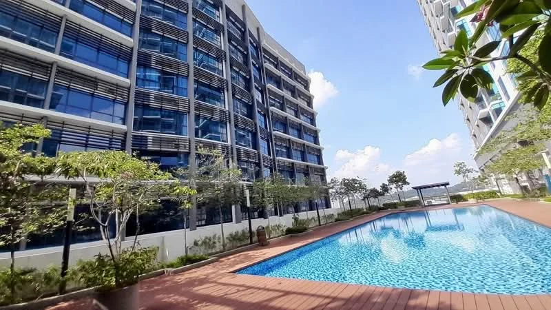 Exterior type: high-rise condominium; features: glass curtain wall facade, approximately 5-storey high-rise, infinity pool, pool deck with loungers, manicured landscaping, trees and shrubs around pool area, outdoor seating pavilion, surrounded by greenery; style: modern.