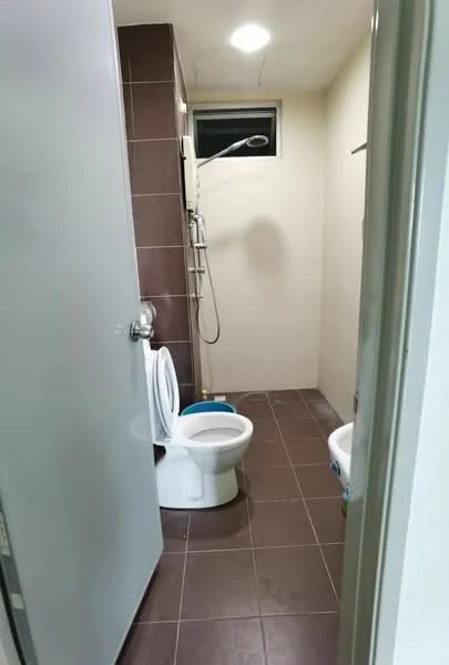 Bathroom features: white toilet, shower with handheld showerhead, tile flooring in brown, light-colored painted walls, small window for natural light, wall-mounted shower control, towel rail, mirror above sink area; style: modern.