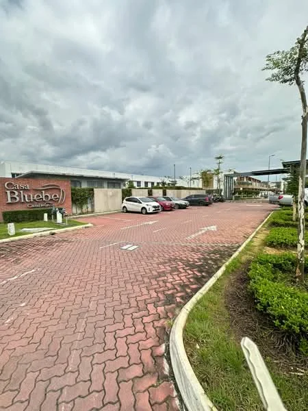 Exterior features: paved driveway, landscaped garden with shrubs, signage with 'Casa Bluebe', multiple parking spaces, surrounding greenery, cloudy sky; style: modern.