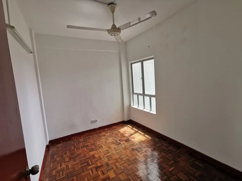 Room features: white painted walls, parquet wood flooring, ceiling fan, single window with multiple panes, natural light from window, corner of room with door, no visible furniture, clean and minimal decor; style: minimalist.