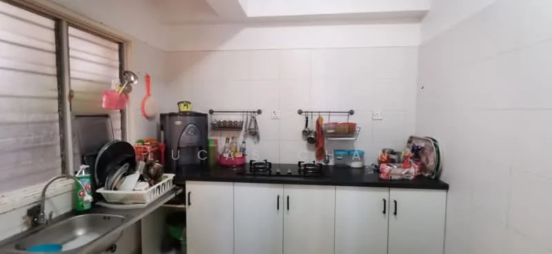Kitchen features: single-bowl stainless-steel sink, chrome pull-down faucet, black countertop, white cabinetry with handles, built-in gas stove with two burners, kitchen utensils on wall-mounted racks, microwave, refrigerator, dish rack, various pots and pans, window with blinds.
