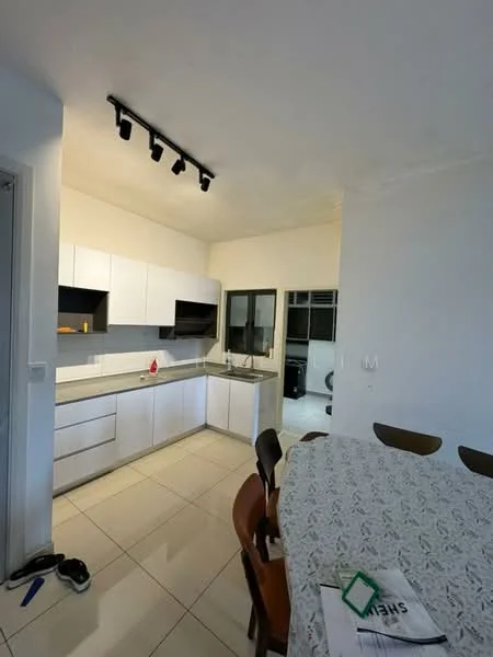 Kitchen features: white flat-panel cabinets, grey countertop, single-bowl stainless-steel sink, chrome pull-down faucet, built-in oven, freestanding range oven, ceramic tile flooring, recessed LED downlights, window with black frame, open layout to dining area; style: modern. Dining features: round dining table, wooden dining chairs, tablecloth with lace pattern; style: modern.