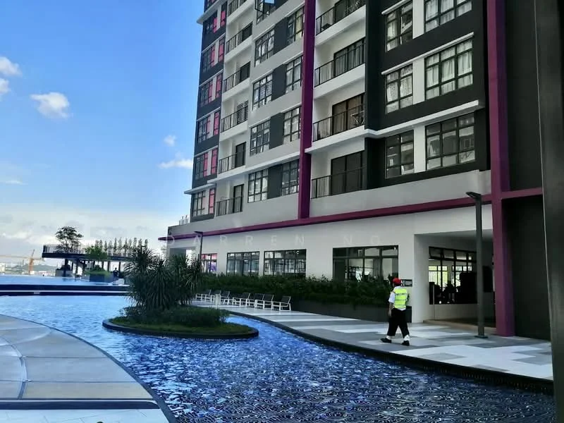 Exterior type: mid-rise condominium; features: glass curtain wall, white painted facade, purple accent panels, landscaped garden with water feature, swimming pool, pool deck with loungers, manicured lawn, outdoor seating area, large windows, balconies, security personnel visible; style: modern.