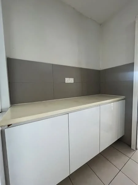 Kitchen features: white cabinetry, grey tiled backsplash, laminate countertop, ceramic tile flooring, wall-mounted electrical outlets, minimalist design, under-cabinet space, neutral wall colour; style: modern.