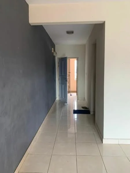 Room features: grey accent wall, white painted walls, glossy ceramic tile flooring, recessed ceiling light, main entrance door, door frame, door mat, open doorway leading to another room; style: modern.