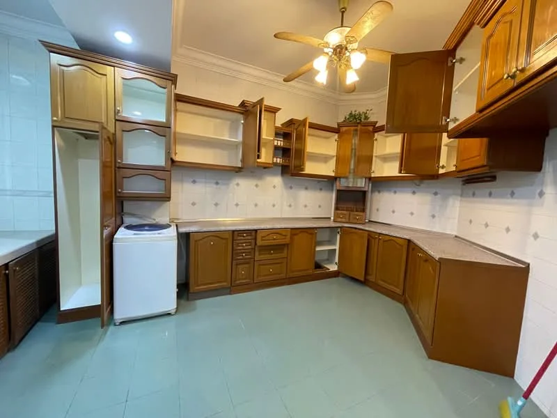 Kitchen features: brown wooden cabinetry, granite countertop, white ceramic tile backsplash, built-in refrigerator space, washing machine, corner sink area, ceiling fan with light, recessed lighting, light green tile flooring, open shelving, upper cabinets with glass doors; style: traditional.