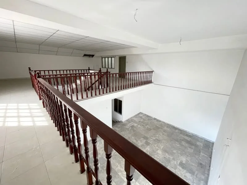 Room features: white painted walls, grey tiled flooring, wooden railing, high ceiling, large windows, open space layout, air conditioning unit, natural light from windows; style: modern.