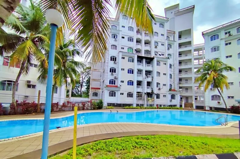 Exterior type: low-rise apartment block; features: swimming pool, palm trees, manicured landscaping, white painted facade, balconies, ground-level pool deck, surrounding greenery, multiple windows, outdoor lighting, poolside loungers; style: modern.