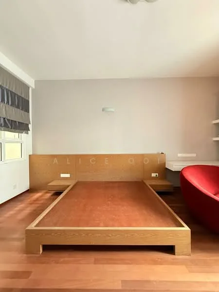 Room features: wooden flooring, light grey painted walls, built-in wooden platform bed, red accent chair, shelf unit, window with blinds, ceiling light fixture; style: modern.