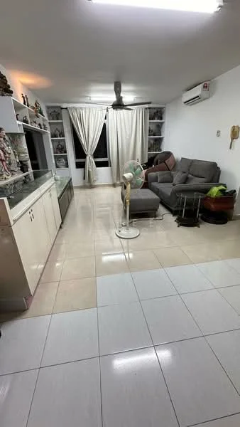 Living features: grey fabric sectional sofa, white painted walls, tile flooring, ceiling fan, wall-mounted air conditioning unit, built-in shelving with decorative items, large window with sheer curtains, standing fan, coffee table, decorative plants; style: modern.