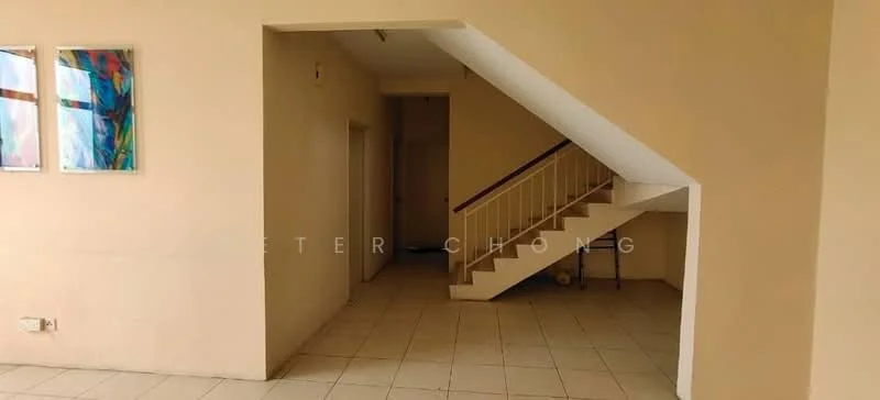 Room features: cream painted walls, white tiled flooring, staircase with white railing, two framed artworks on wall, doorway leading to another room, open space layout.