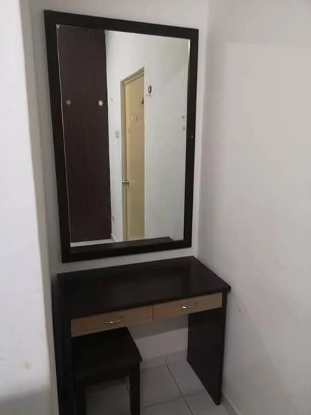 Room features: wooden dressing table with two drawers, large rectangular mirror, white tiled flooring, plain white walls, brown accent wall, door leading to another room; style: modern.