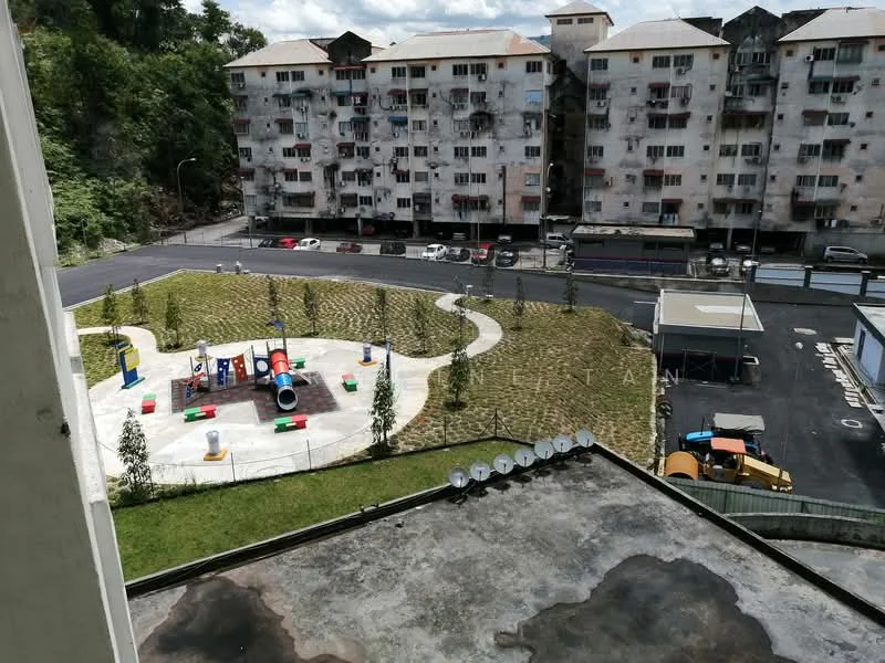Exterior type: low-rise apartment block; features: playground with colorful equipment, manicured lawn, paved walkway, parking area, surrounding greenery, multiple-storey apartment building, visible balconies, asphalt road; style: modern.