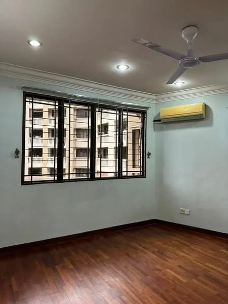 Room features: light brown wooden flooring, white painted walls, recessed downlights, 1 wall-mounted split AC, ceiling fan, black metal window grills, large windows with multiple panes.