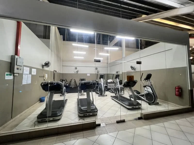 Room features: treadmills, elliptical machines, wall-mounted fans, large glass windows, tile flooring, overhead fluorescent lighting, mirrored wall, exercise mats, fire extinguisher, exercise equipment, white painted walls, grey accent wall; style: modern.