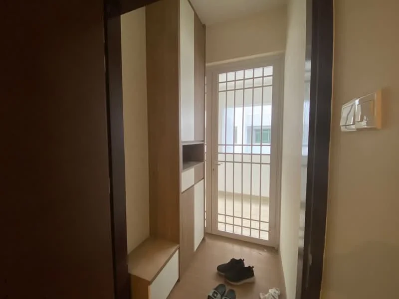 Room features: wooden cabinetry, white painted walls, light-colored flooring, built-in storage unit, sliding door, security grille, natural light from window, space for shoes, minimalist design; style: modern.