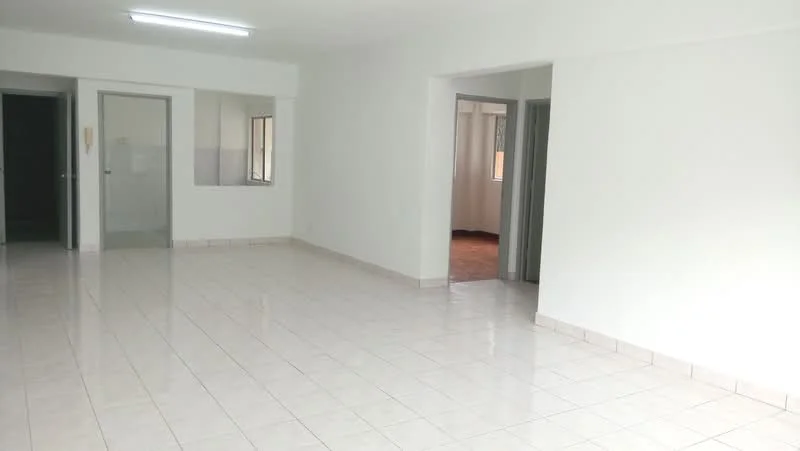 Room features: white painted walls, glossy ceramic tile flooring, fluorescent ceiling lights, multiple doorways, large windows, neutral color scheme, open layout, no visible furniture; style: minimalist.