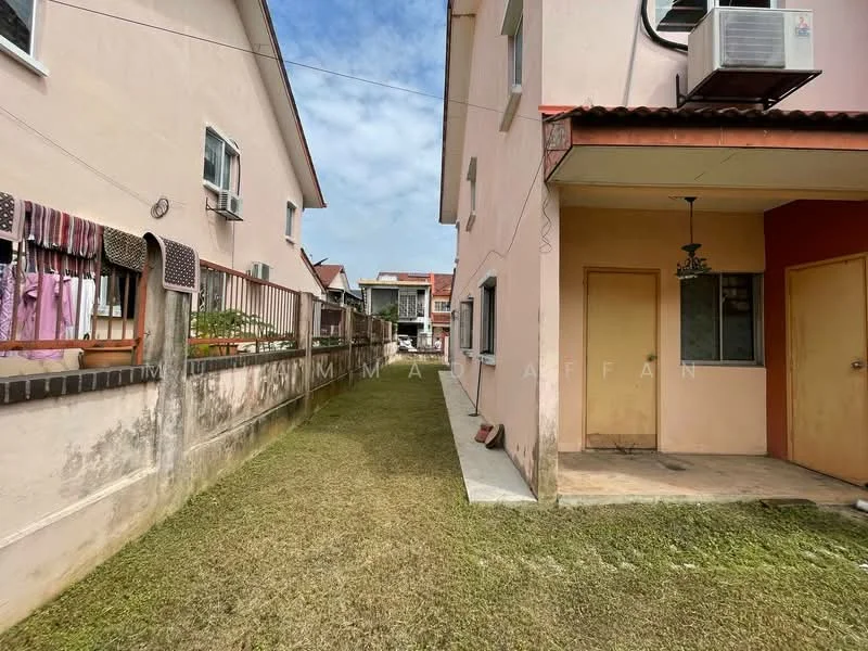Exterior type: linked terrace house; features: pink painted facade, single-storey, manicured lawn, side walkway, air conditioning unit on wall, doorway with awning, adjacent houses visible, fenced area; style: modern.