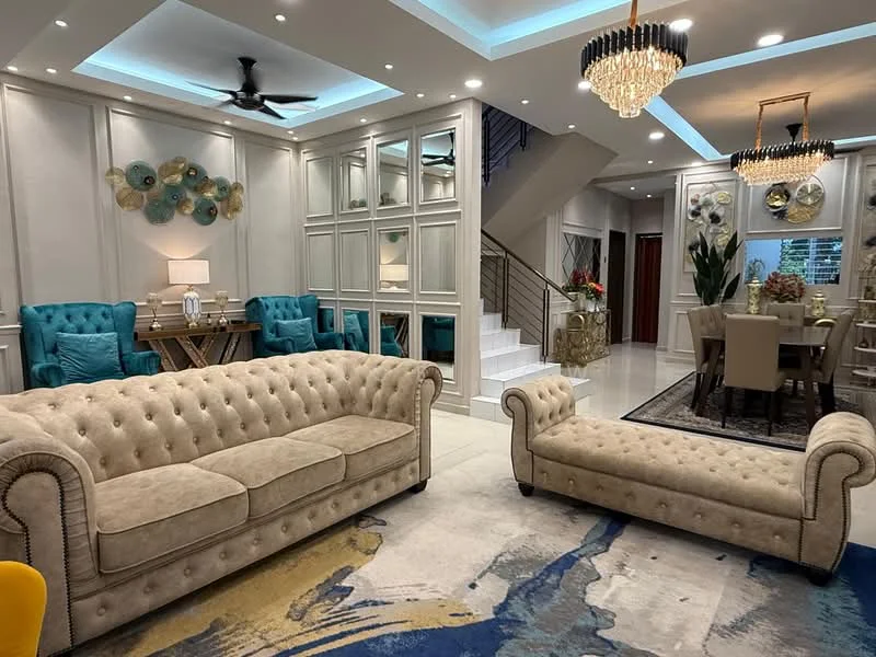 Living features: chesterfield-style beige sofa, beige chaise lounge, blue upholstered accent chairs, glass chandelier, recessed LED downlights, tray ceiling with LED lighting, decorative wall panels, large area rug with abstract pattern, wooden dining table, dining chairs with upholstery, decorative wall art, indoor plants; style: modern.