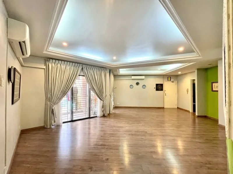 Living features: wooden flooring, tray ceiling with recessed lighting, floor-to-ceiling sliding glass door, sheer curtains, air conditioning unit, wall-mounted decor, green accent wall, neutral painted walls; style: modern; view: garden.