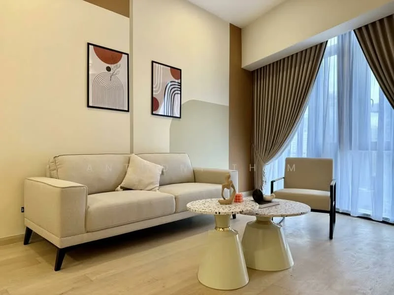 Living features: beige fabric 3-seater sofa, round coffee table with speckled top, single accent chair in light color, floor-to-ceiling windows, sheer curtains, decorative wall art with abstract designs, light wood flooring, painted walls in cream and brown tones; style: modern.