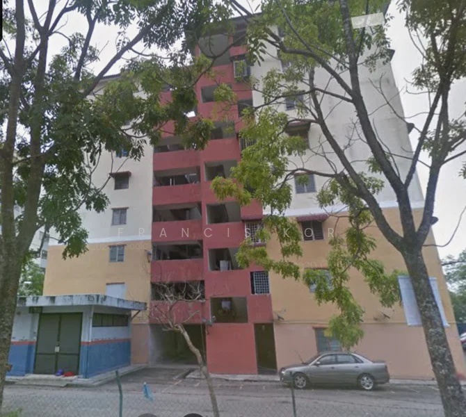 Exterior type: low-rise apartment block; features: red and cream painted facade, multiple balconies, ground floor parking area, surrounded by trees, visible windows, two-storey building, car parked in front; style: modern.