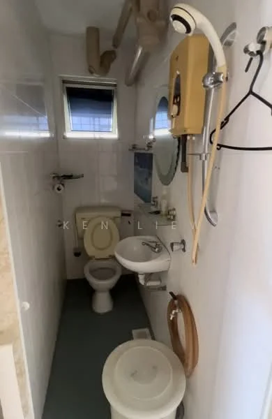 Bathroom features: white tiled walls, green vinyl flooring, one-piece toilet, sink with pedestal, mirror, shower head, grab bar, toilet paper holder, handheld shower, window, wall-mounted water heater.