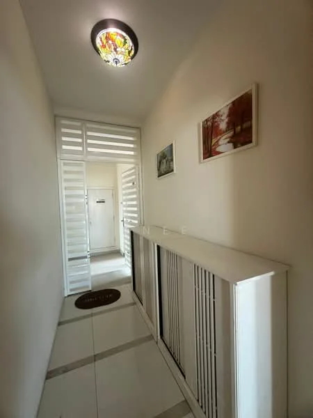Hallway features: white painted walls, glossy tile flooring, stained glass ceiling light, built-in cabinetry, decorative wall art, doorway with louvered panels, doormat, neutral color scheme; style: modern.