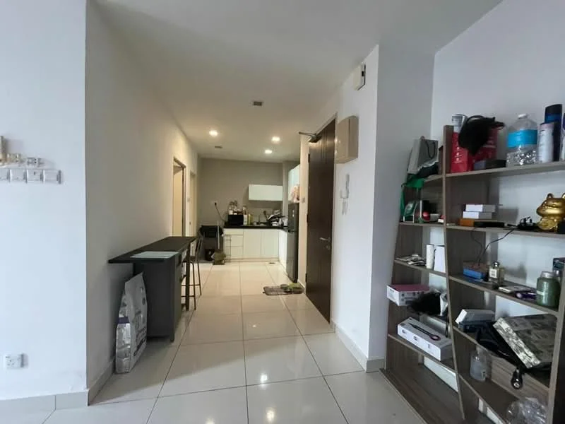 Room features: white painted walls, glossy white tile flooring, open layout, kitchen area visible, counter with bar stools, shelving unit with decor items, doorway leading to other rooms, recessed lighting, modern cabinetry in kitchen, appliances visible in kitchen area; style: modern.