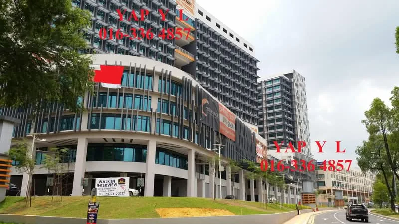 Exterior type: high-rise condominium; features: glass curtain wall, projecting balconies, multiple storeys, manicured landscaping, driveway with interlocking pavers, signage visible on facade, surrounded by mature greenery; style: modern.