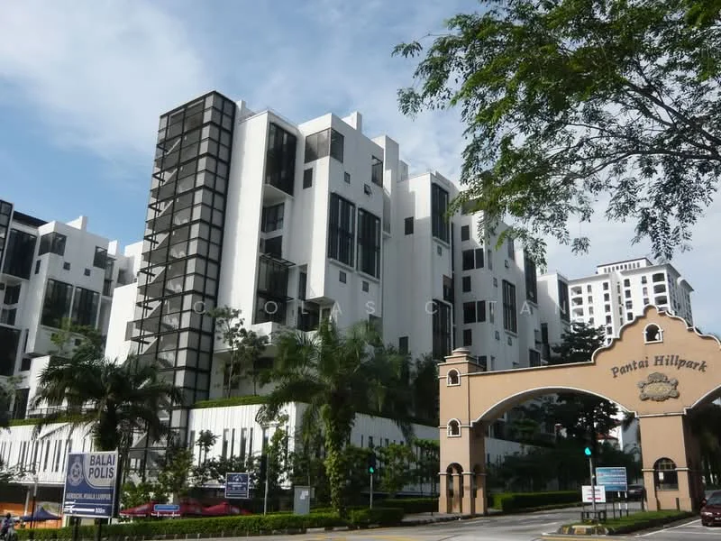 Exterior type: low-rise apartment block; features: white painted facade, glass curtain wall, recessed balconies, manicured landscaping, palm trees, stone-paved walkway, gated entry, guard house at entrance, double-volume main lobby, feature water wall; style: modern.