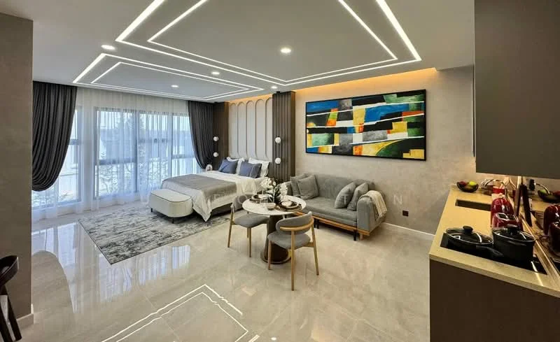 Living features: king-size bed with upholstered headboard, 2 bedside lamps, sofa in light grey fabric, coffee table, area rug with geometric pattern, large window with sheer curtains, wall-mounted artwork with abstract design, recessed LED downlights, marble tile flooring, wall paneling with vertical lines, dining table with 2 chairs, open kitchen area with countertop; style: modern; view: garden.