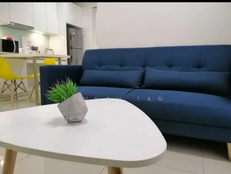 Living features: blue fabric sofa with three cushions, white coffee table, small potted plant on table, white painted walls, glossy tile flooring, recessed LED downlights, kitchen area visible in background, microwave on countertop, stainless-steel fridge, yellow dining chairs, kitchen cabinets, open-plan layout; style: modern.