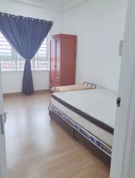 Bedroom features: wooden flooring, white painted walls, large window with horizontal bars, blue curtain, brown wooden wardrobe, single bed frame, mattress, wooden bedside table.