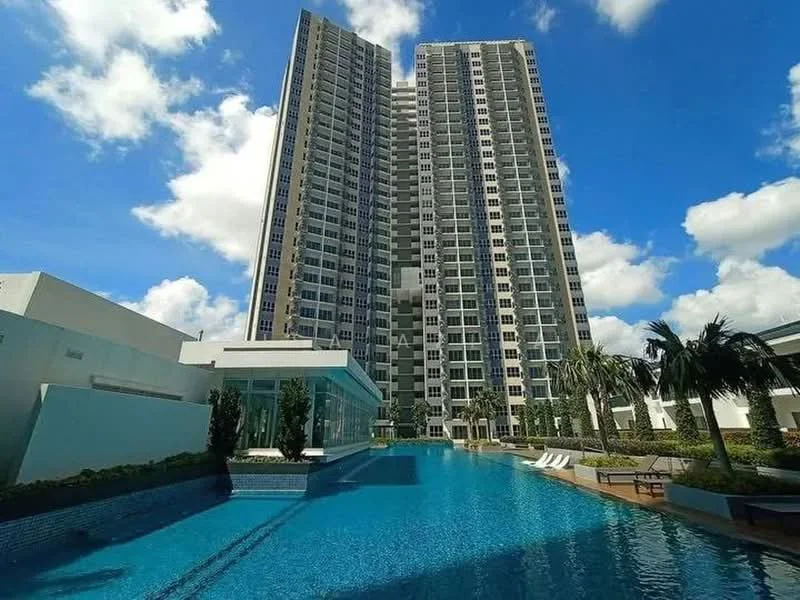 Exterior type: high-rise condominium; features: infinity pool, pool deck with loungers, glass curtain wall facade, tropical landscaping with palm trees, manicured lawn, surrounded by greenery, multiple storeys, modern architectural design; style: modern.
