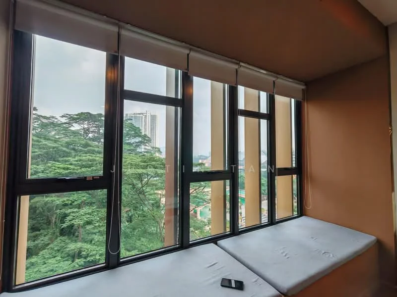 Room features: floor-to-ceiling windows, grey window frames, roller blinds, built-in window seat with cushion, brown painted walls, view of greenery, urban skyline in background; style: modern; view: garden.