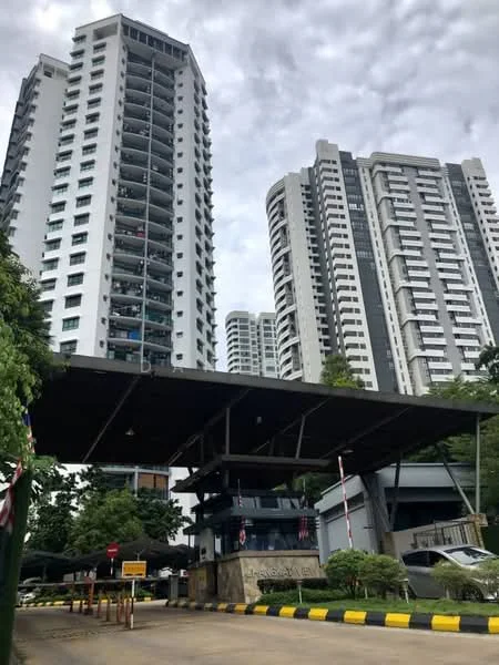 Exterior type: high-rise condominium; features: two high-rise buildings, modern architectural design, covered entrance with awning, security guardhouse at entrance, landscaped greenery, paved driveway, visible balconies on residential units, parking area, surrounded by mature trees; style: modern.