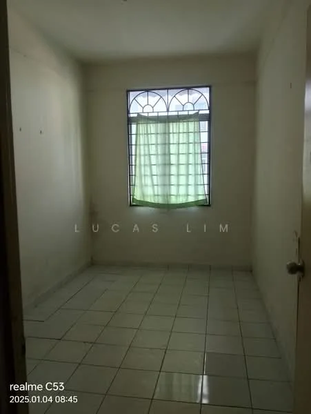 Room features: white painted walls, white tiled flooring, single window with grid design, green sheer curtains, door with knob, no visible furniture or decor.